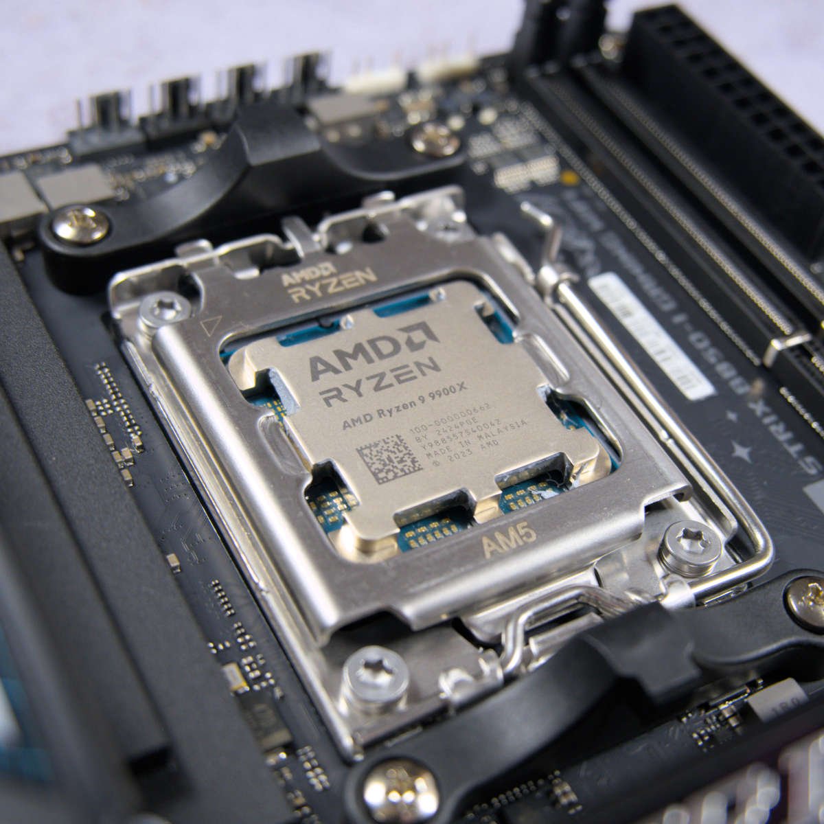 Ryzen 9 9900X nestled in CPU socket of Asus ROG Strix B850-I Gaming motherboard.
